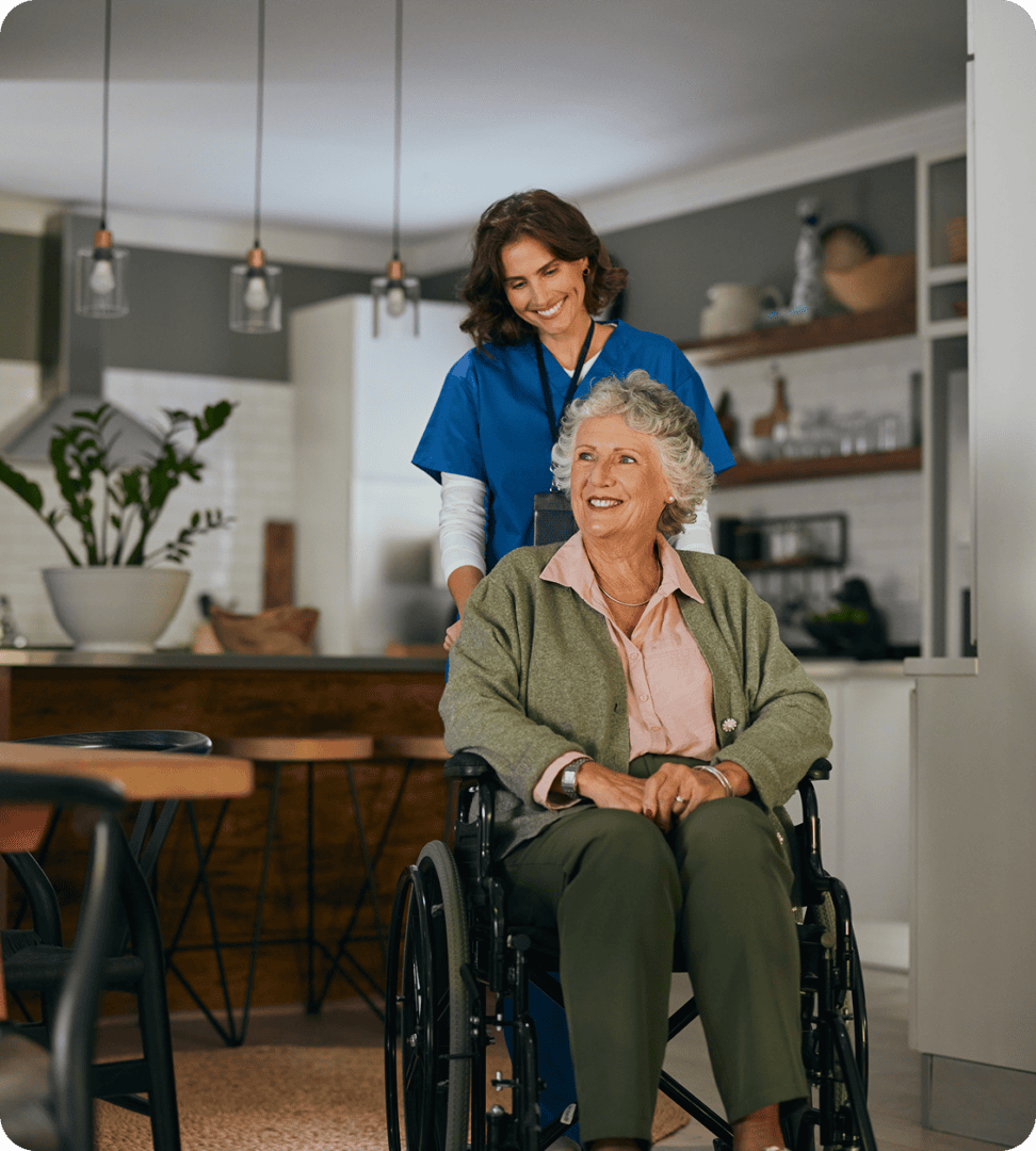 Caregiver assisting elderly woman in wheelchair