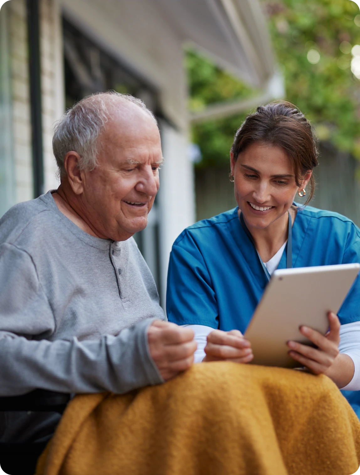 Elderly man and nurse with a tablet