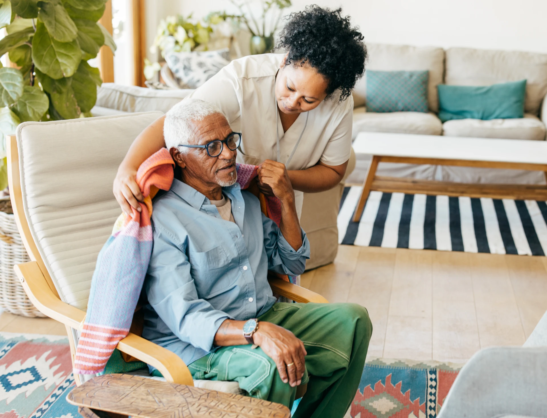 Elderly man receiving a colorful shawl