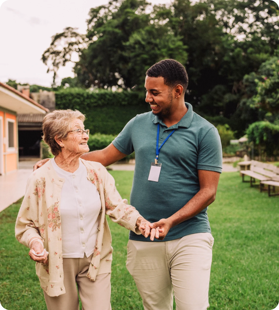 Elderly woman and caregiver walking outside